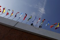 A photo taken from below a row of flags from around the world