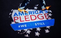 Two feet are shown walking on an “America's Pledge” logo
