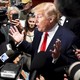 Donald Trump is surrounded by reporters holding cameras and microphones as he addresses the media during the National Federation of Republican Assemblies, in Nashville, in 2015.