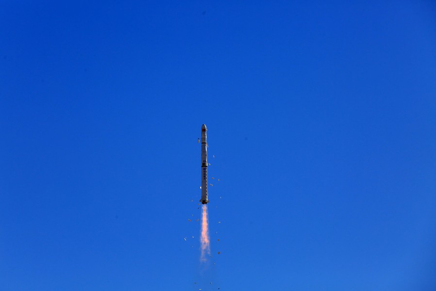 A rocket climbs into the sky.