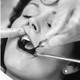 Side by side black and white photos. On the left, a woman cradling a newborn baby. On the right, a close up of a woman's mouth with hands inserting a dental mirror