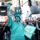 A person dressed in a Statue of Liberty costume participates in a "No Kings" national day of protest in New York.