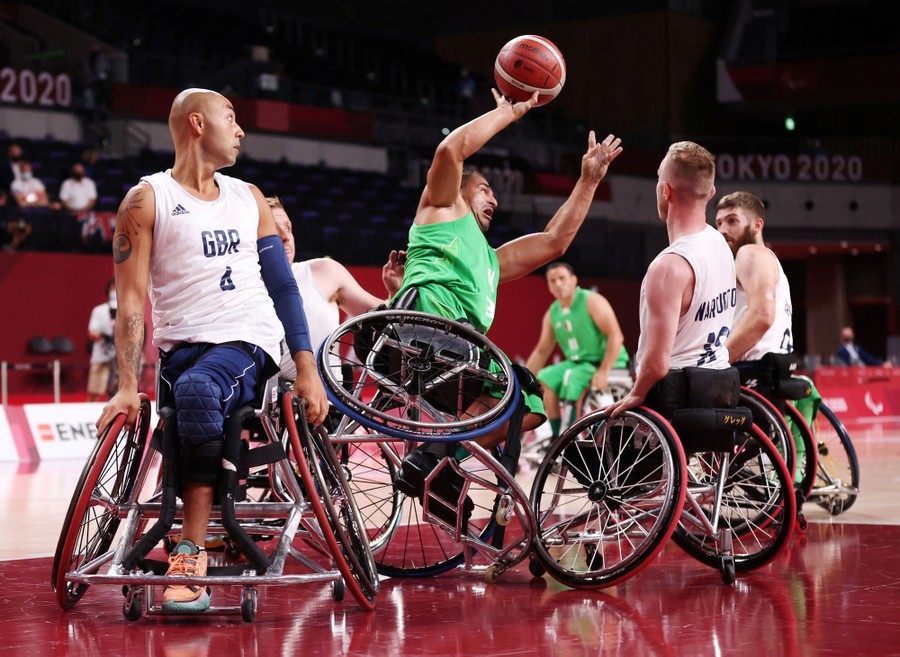 Two teams play wheelchair basketball.
