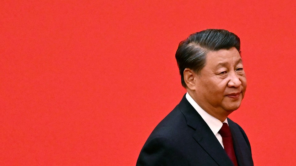 Xi Jinping, wearing a suit and tie, looks downcast in the bottom right of a plain red field.