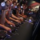 People sit with headphones on staring at computer screens.