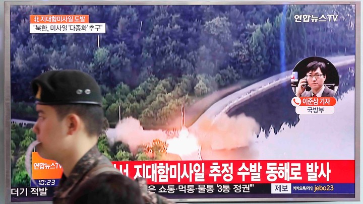 A South Korean soldier walks past a TV broadcast of a news report on North Korea firing what appeared to be several land-to-ship missiles off its east coast, at a railway station in Seoul, South Korea, on June 8, 2017.