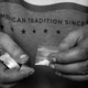 Hands holding a packet of white powder