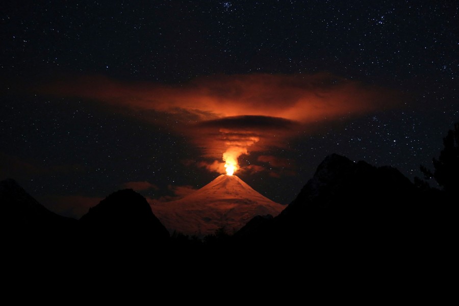 An erupting volcano at night