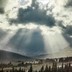 Photo of Glacier National Park, Montana, with light streaming through the clouds
