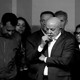 Black-and-white photo of Luiz Inácio Lula da Silva, surrounded by other people