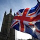 Anti-Brexit demonstrators wave EU and Union flags outside the Houses of Parliament in London on January 30, 2018.