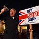 Boris Johnson with a sign reading "Get Brexit Done."