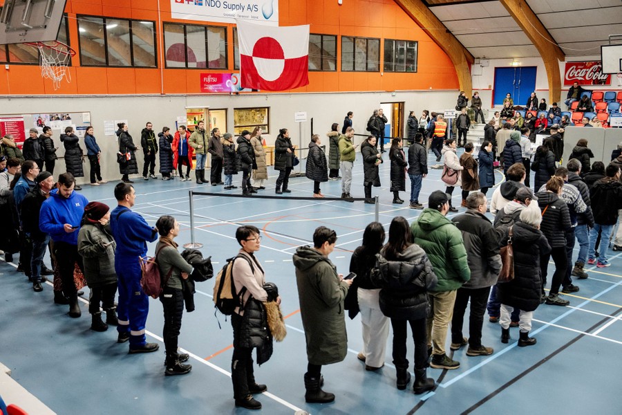 People line up to vote inside a polling station.