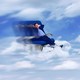 A man relaxing on a plane seat hovering among clouds in a blue sky