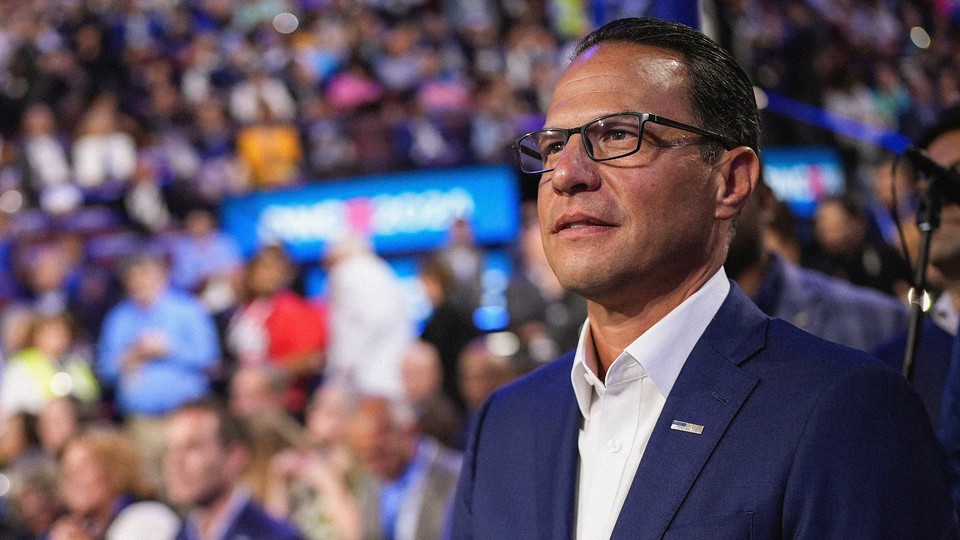 Josh Shapiro, with an out-of-focus crowd behind him