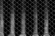 Supreme Court columns behind chain-link fence