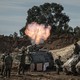 Photo of Israeli soldiers around a mortar launcher firing toward Gaza from Be'eri, Israel, on Tuesday, October 17, 2023.