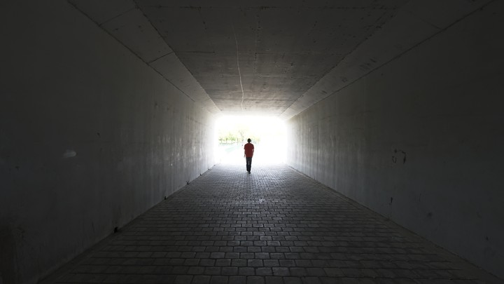 A person walks out of a tunnel