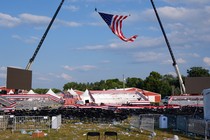 The American flag hangs over a field covered with black folding chairs and litter after Donald Trump's weekend rally was evacuated.