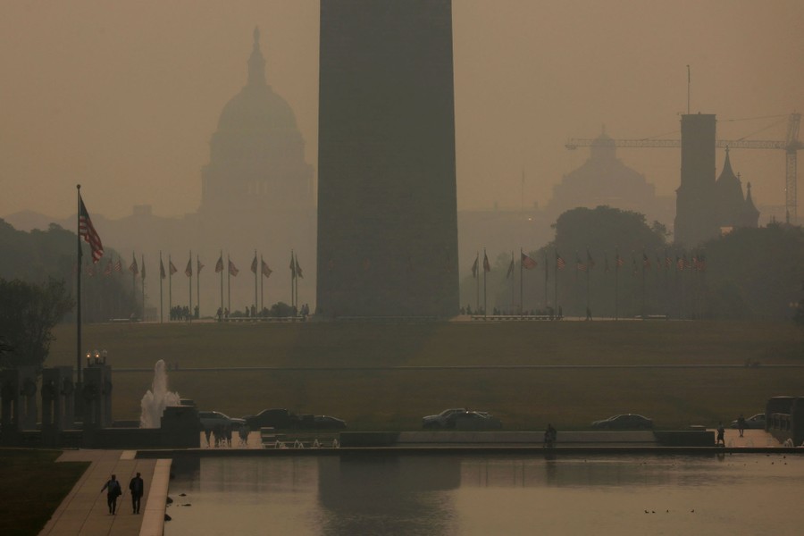 A view of the Washington Monument and the U.S. Capitol building through a hazy sky