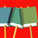 Books on sticks like picket signs against a red background