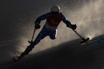 A skier makes a tight turn during a slalom run.