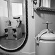 A black-and-white photo looking into a gas chamber in a San Quentin, California prison