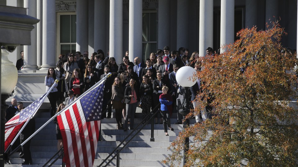 Onlookers hoping to get a view of President-elect Donald Trump stand outside the White House in Washington, D.C., on November 10.