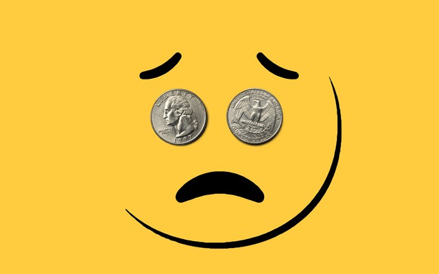 A frowning face with two quarters for eyes
