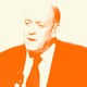 Francis Davis in a suit speaking into a microphone