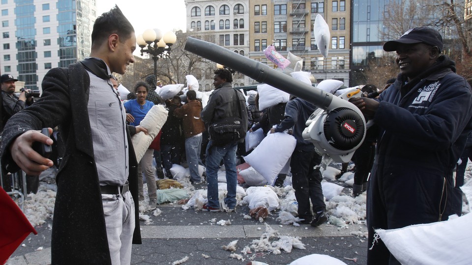 Constructive use of a battery-powered leaf blower, to remove feathers after a big pillow fight, in New York.