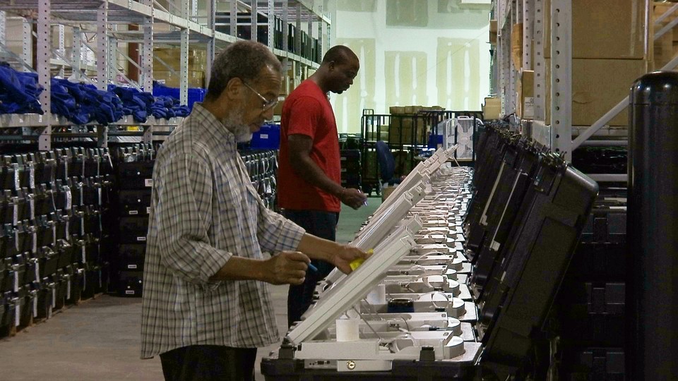 Voters use electronic voting machines.
