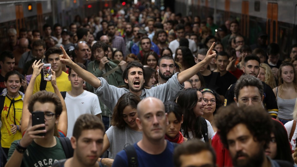 A man shouts slogans during a regional strike called by pro-independence parties and unions in Barcelona, Spain on October 3, 2017.