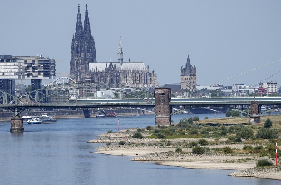 A view of Cologne, Germany, along a river with very low water
