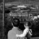 A family looks at the wreck in East Palestine.