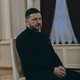 A color photograph of Zelensky seated and looking off camera during an interview