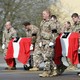 The coffins of two Danish soldiers who were killed in Afghanistan are draped in Danish flags and carried out of a military transport plane in Denmark by men in military uniforms.