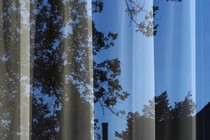 a sheer curtain with a blue night seen through it