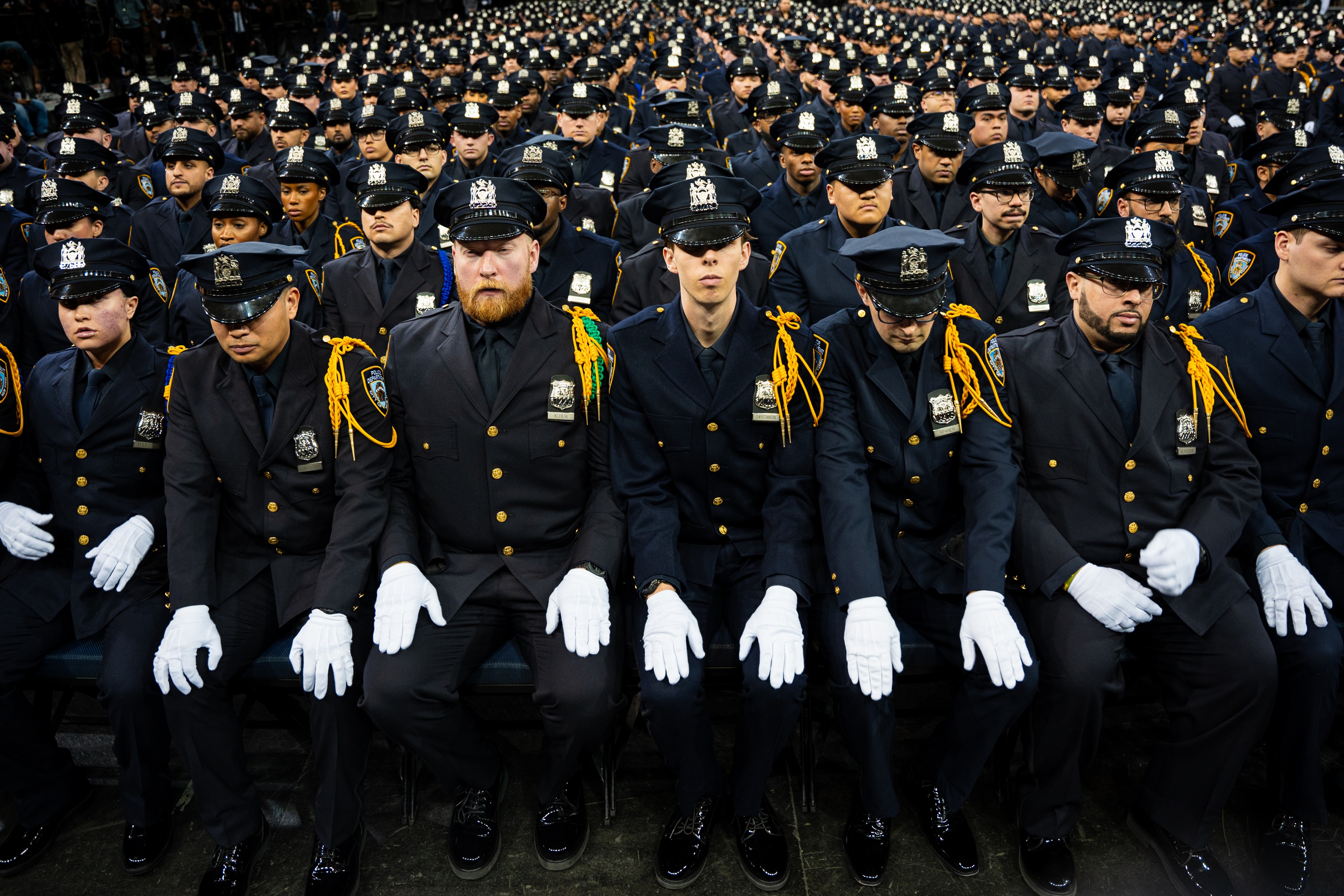 Police Academy graduates sit in dress uniforms, during the NYPD Graduation ceremony.