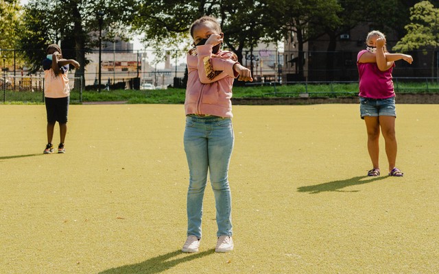 Children stretch at a summer camp in New York, Aug. 17, 2020.