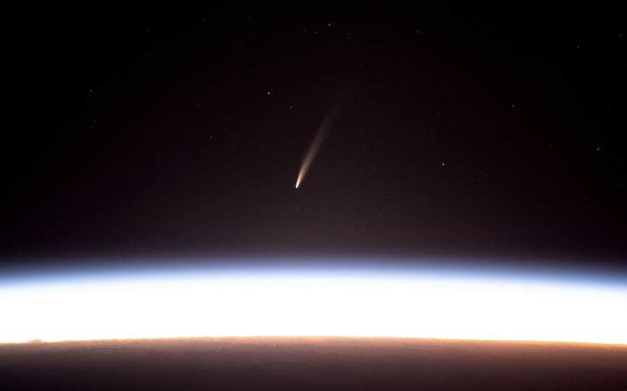 A comet, seen just above the Earth's horizon