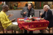 Larry David eating at a restaurant with two friends