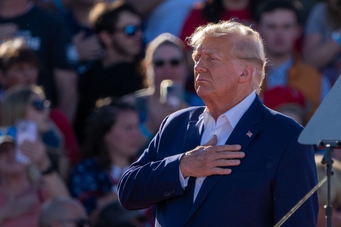 Donald Trump holds his hand over his heart during a 2024 campaign rally in Waco Texas on March 25 2023