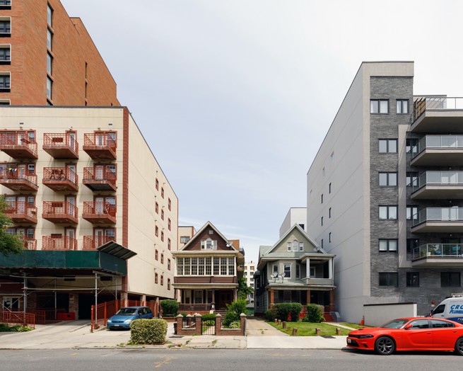 two single family homes between mid-rise condo buildings in flatbush