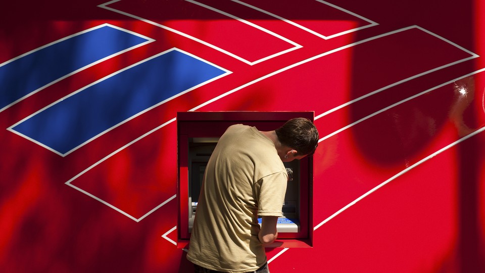 A man using a Bank of America ATM