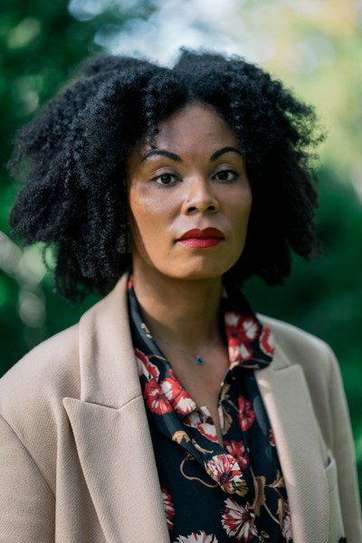 photo of woman with black hair wearing jacket over floral blouse