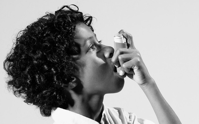 Photo of a person using an inhaler