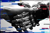 A man shakes hands with a humanoid robot during the International Conference on Humanoid Robots in Madrid, in 2014.