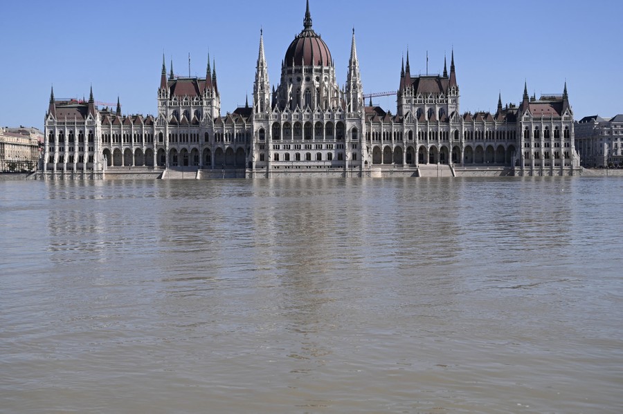A flooding river reaches up to the steps of a large parliament building in Hungary.