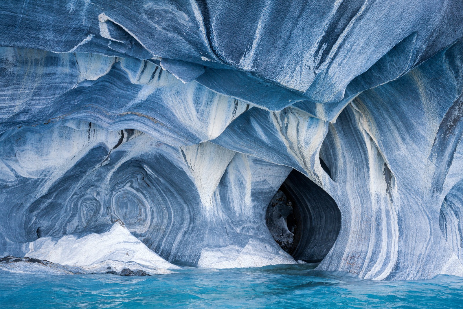 Swirling lines in a shoreline rock that has been eroded and carved by wave action